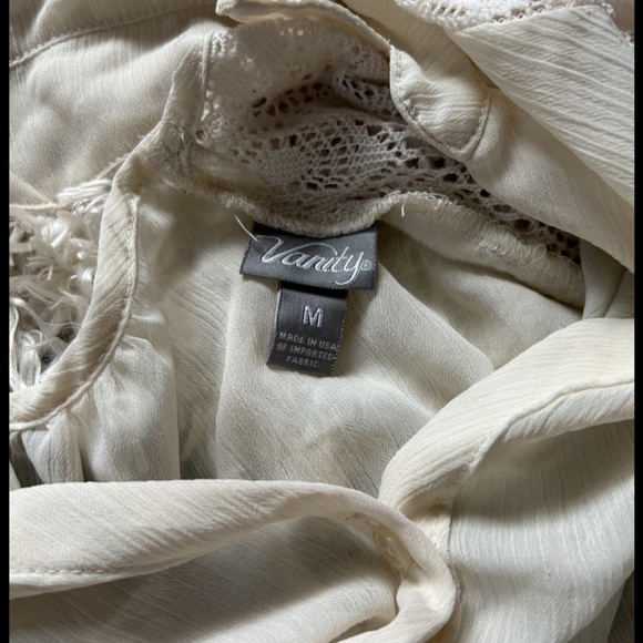 From Vanity it’s a cream colored dressy button down shirt and is a size M - Picture 3 of 3
